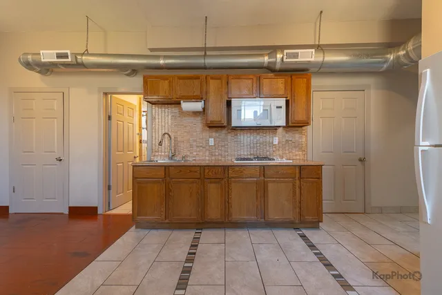 a kitchen with a sink and cabinets