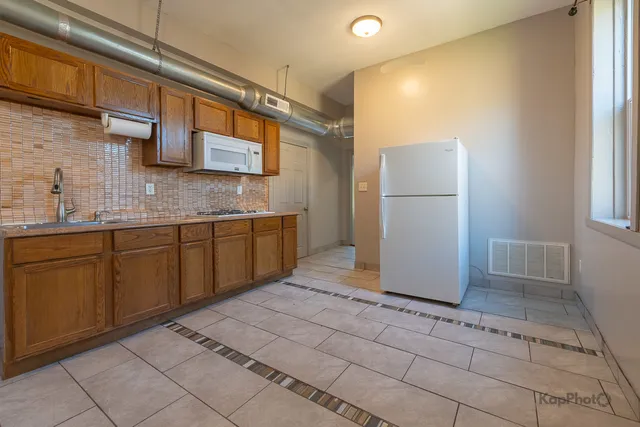 a view of a kitchen with a sink and cabinets