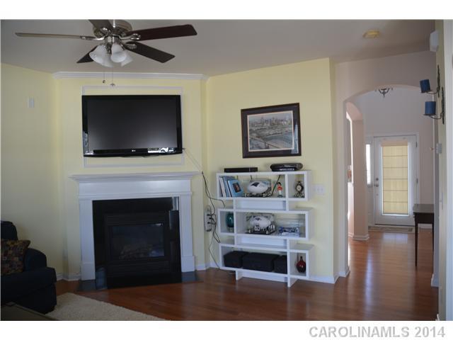 6533 Del Rio Road Charlotte, NC 28277 - Photo 11 of 15 a living room with furniture a flat screen tv and a fireplace