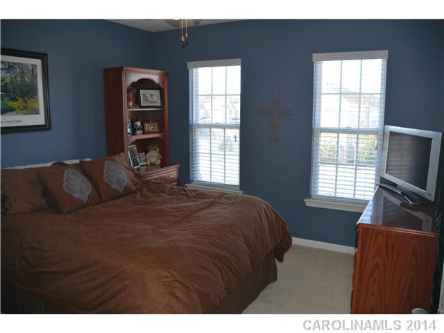 6533 Del Rio Road Charlotte, NC 28277 - Photo 13 of 15 a bedroom with a bed flat screen tv and a window