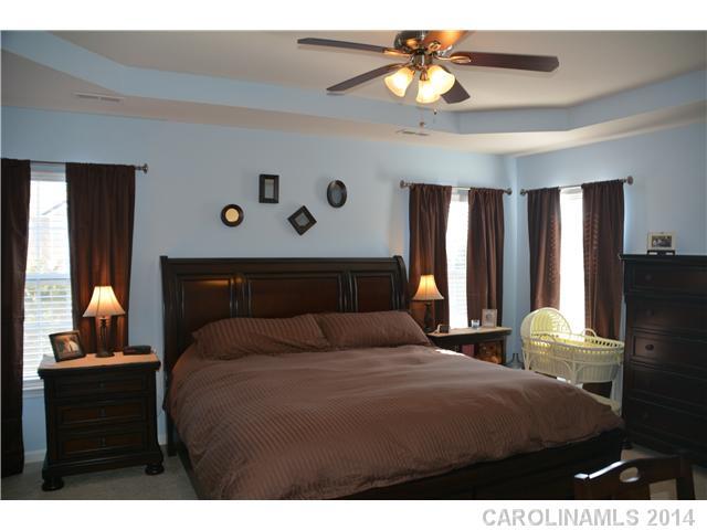 6533 Del Rio Road Charlotte, NC 28277 - Photo 14 of 15 a bedroom with a bed and a chandelier