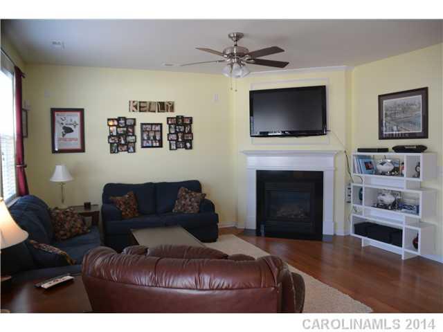 6533 Del Rio Road Charlotte, NC 28277 - Photo 7 of 15 a living room with furniture a flat screen tv and a fireplace