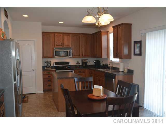 6533 Del Rio Road Charlotte, NC 28277 - Photo 9 of 15 a kitchen with a refrigerator and a stove top oven