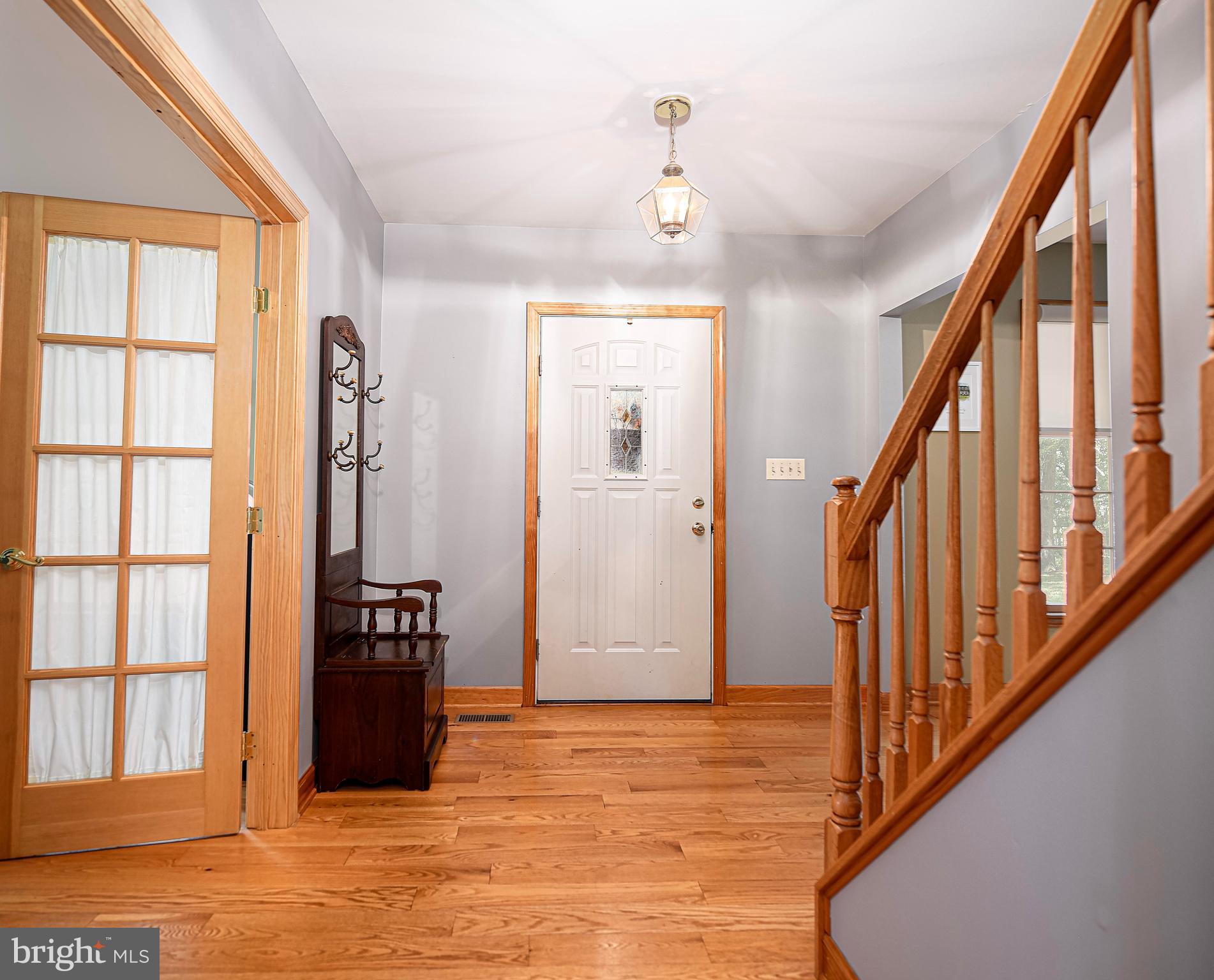 Foyer w/ wide plank hardwood floors