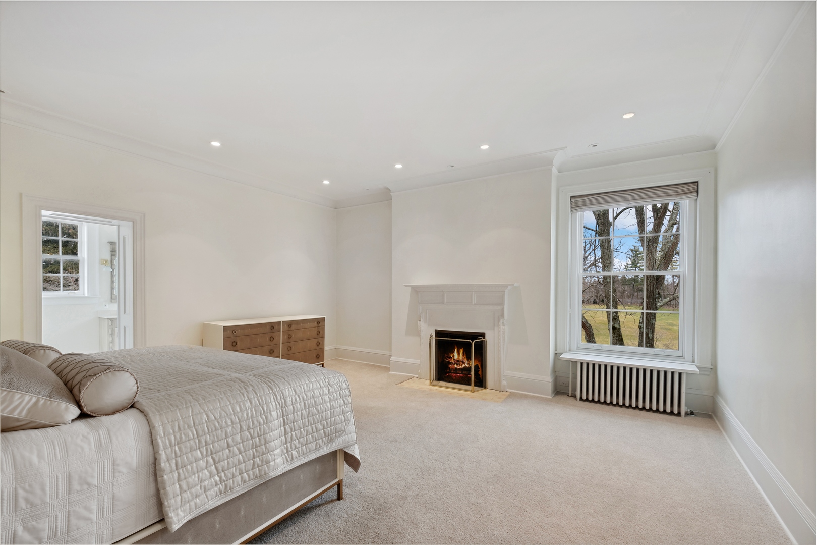 100 Pembroke Drive Lake Forest, IL 60045 - Photo 38 of 56 a bedroom with a balcony a bed and a fireplace