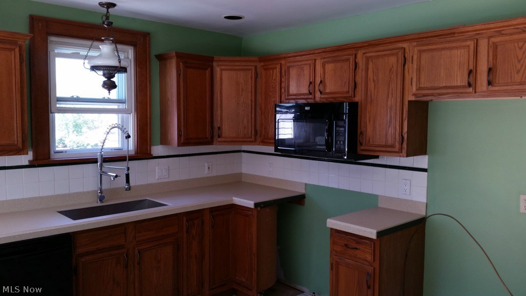 4484 Grayton Road Cleveland, OH 44135 - Photo 12 of 20 Eat in kitchen with solid surface counters, microwave oven, deep custom SS sink, high end dishwasher with SS interior, custom faucet, recessed ceiling lighting, great views of the Metro Park.