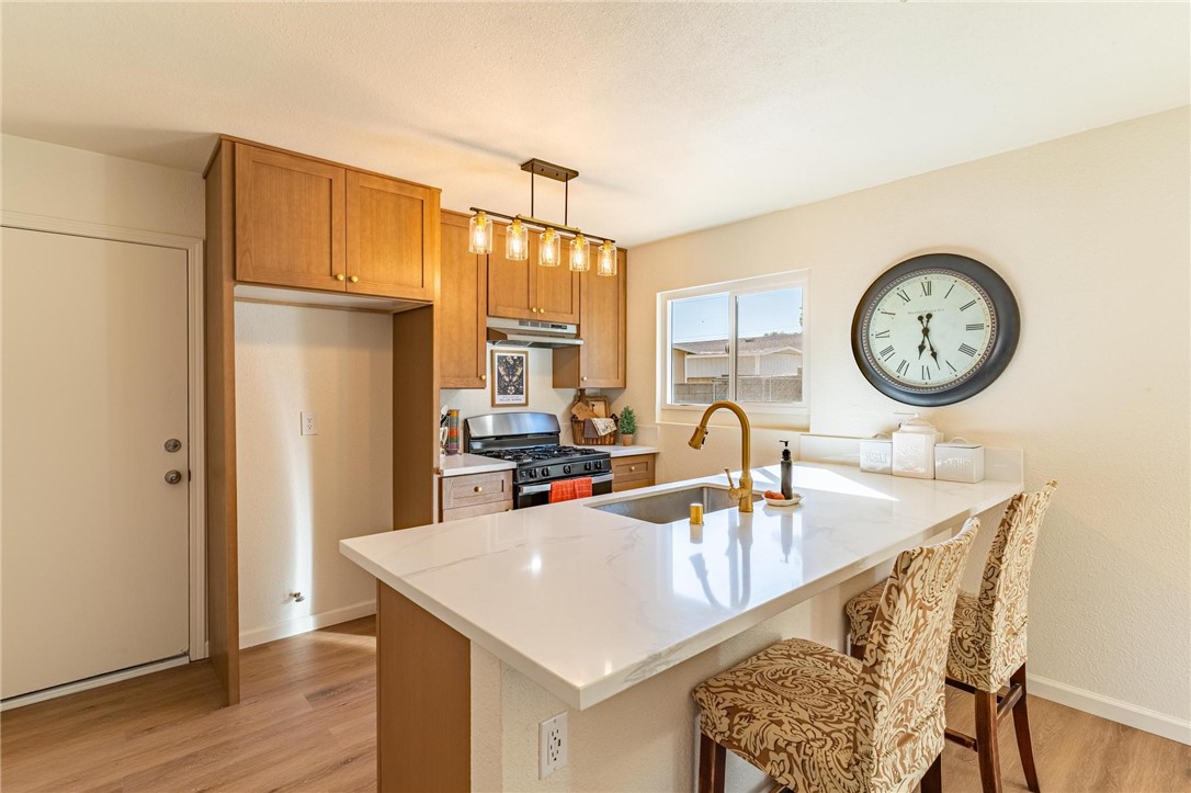 7738 Encinitas Avenue Fontana, CA 92336 - Photo 11 of 35 a kitchen with a table and chairs