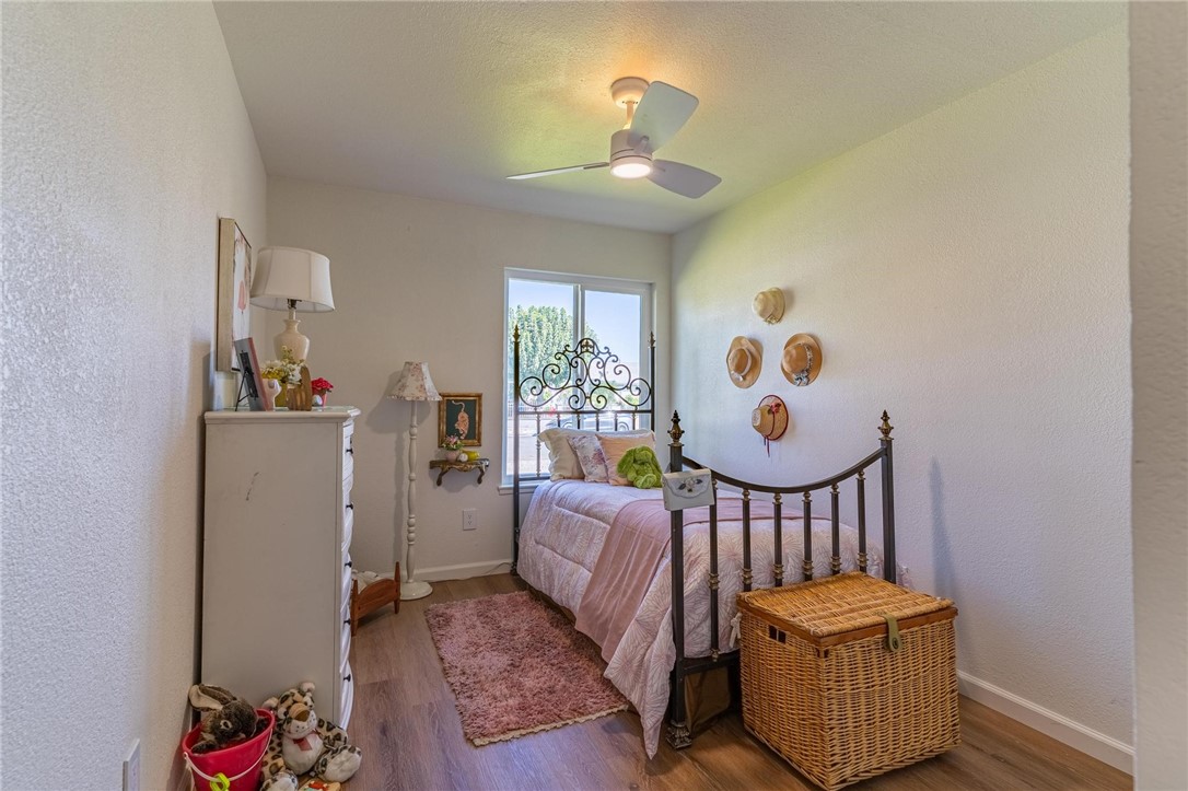7738 Encinitas Avenue Fontana, CA 92336 - Photo 23 of 35 a bedroom with furniture and wooden floor