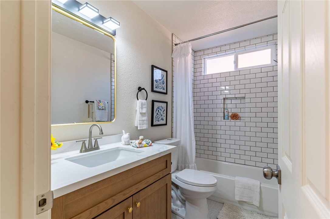 7738 Encinitas Avenue Fontana, CA 92336 - Photo 26 of 35 a bathroom with a sink a toilet and shower