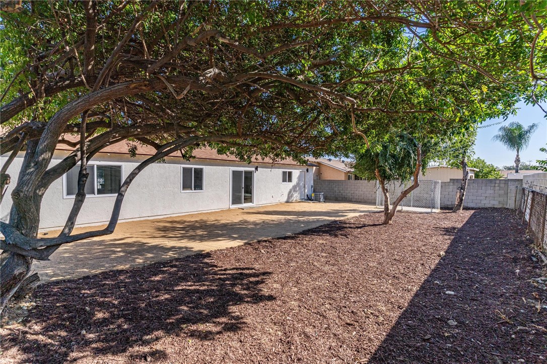7738 Encinitas Avenue Fontana, CA 92336 - Photo 29 of 35 a backyard of a house with large trees
