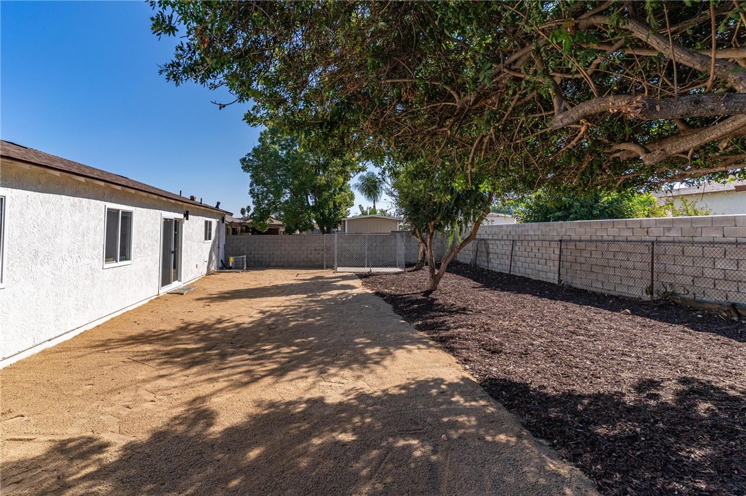 7738 Encinitas Avenue Fontana, CA 92336 - Photo 30 of 35 a view of a yard with wooden fence