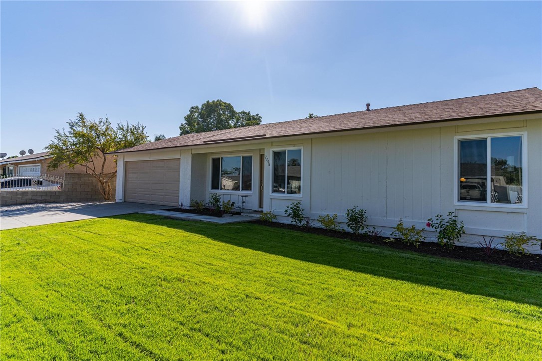 7738 Encinitas Avenue Fontana, CA 92336 - Photo 4 of 35 a backyard of a house with lots of green space and garden