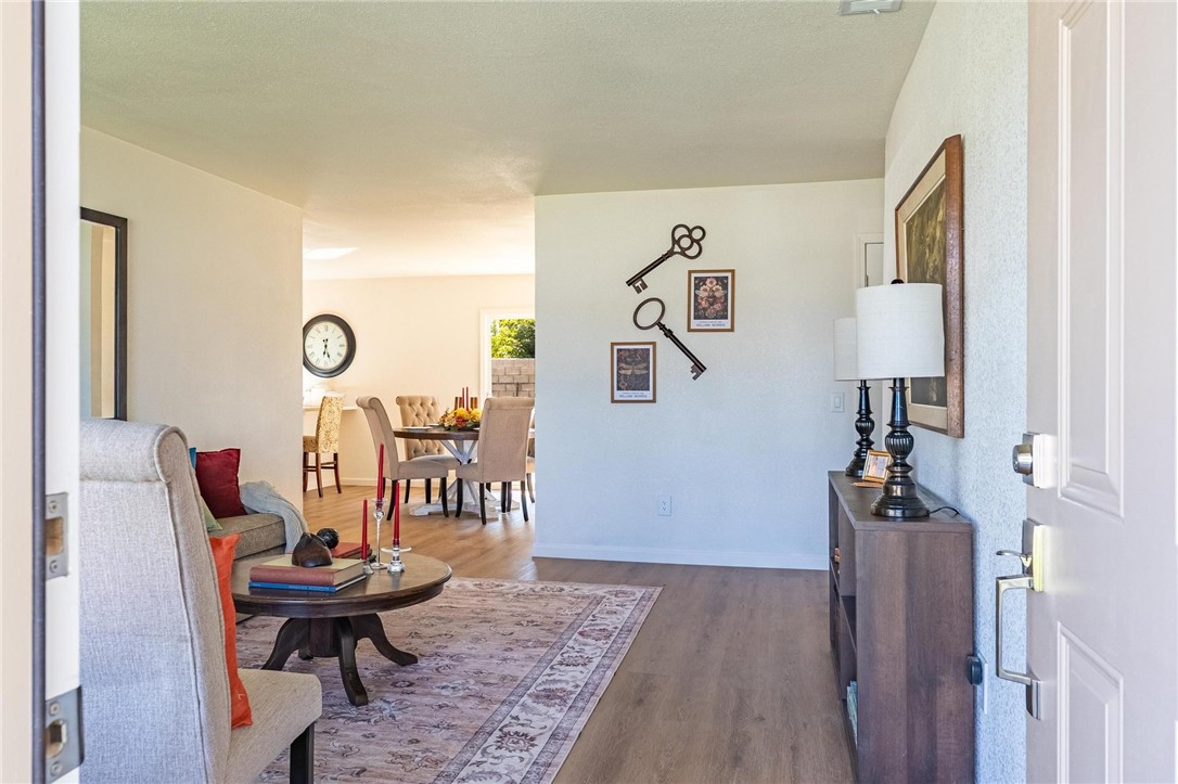 7738 Encinitas Avenue Fontana, CA 92336 - Photo 6 of 35 a living room with furniture and wooden floor