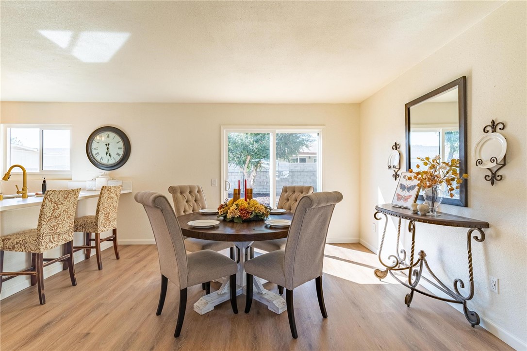 7738 Encinitas Avenue Fontana, CA 92336 - Photo 10 of 35 a view of a dining room with furniture and wooden floor