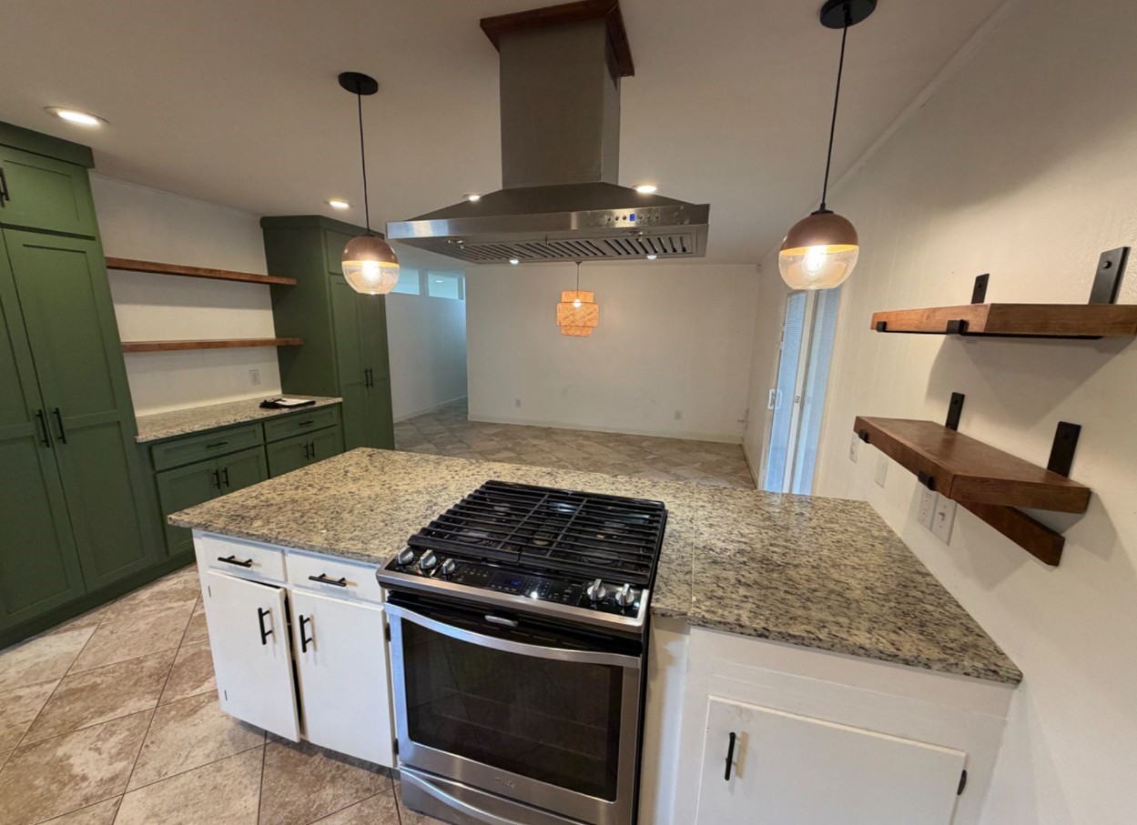 7314 Cannock Road Houston, TX 77074 - Photo 6 of 6 a kitchen with stainless steel appliances granite countertop a sink a stove and a wooden floors
