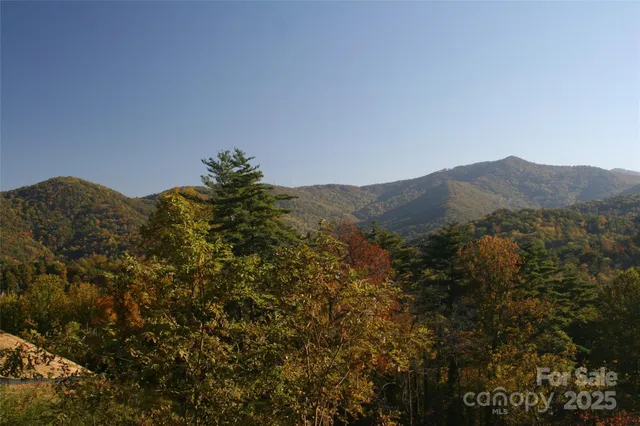 a view of a large building with mountains in the background