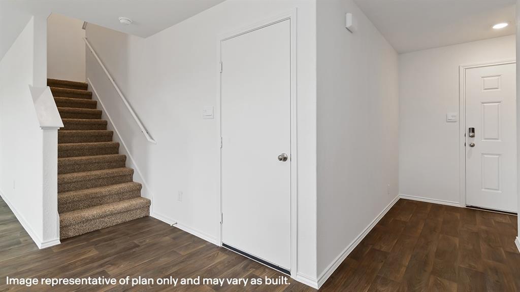 a view of a hallway with wooden floor and entryway