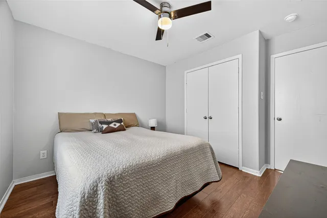 a bedroom with a bed and wooden floor