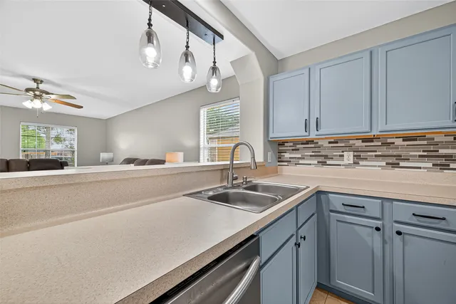 a kitchen with a sink and cabinets