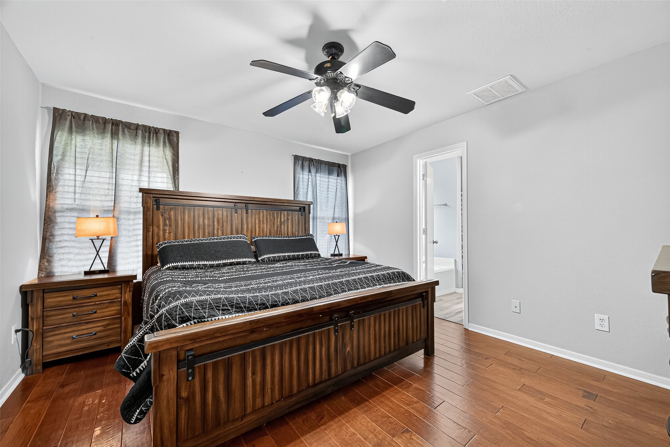 919 Wild Cotton Road Rosenberg, TX 77471 - Photo 9 of 21 a bedroom with a bed and wooden floor