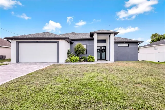 a front view of a house with a yard