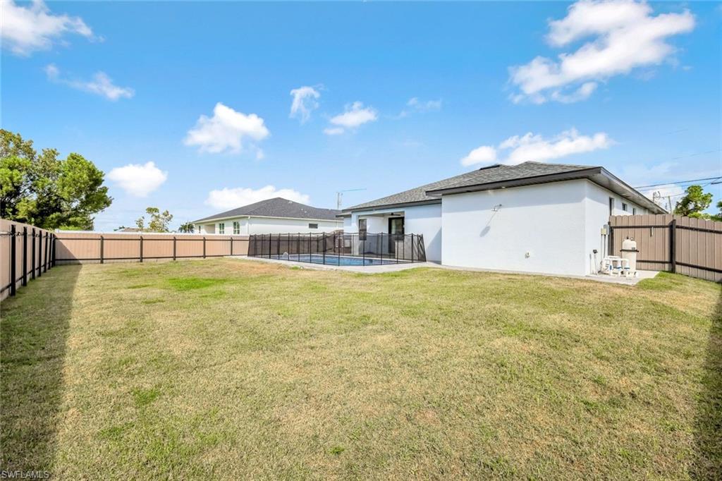 502 Southwest 25th Place Cape Coral, FL 33991 - Photo 13 of 34 a view of a house with a backyard