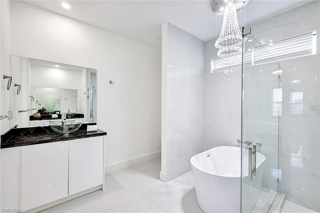 502 Southwest 25th Place Cape Coral, FL 33991 - Photo 14 of 34 a bathroom with a granite countertop sink a toilet a mirror and shower