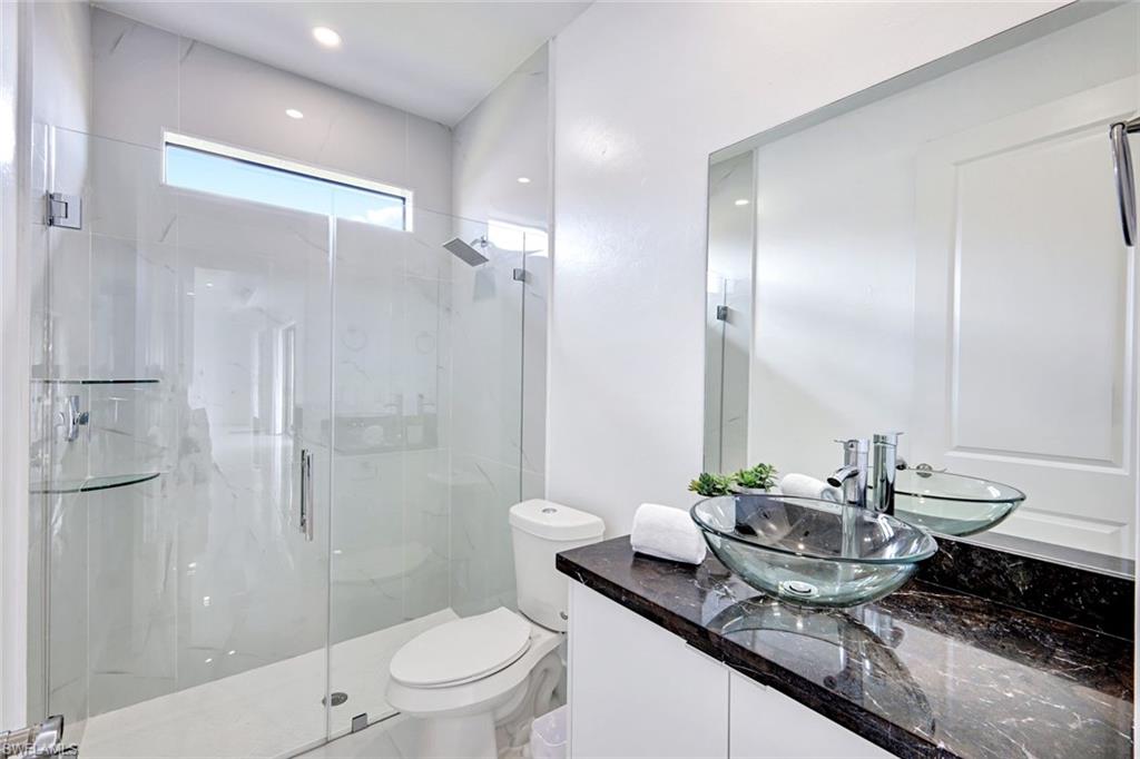 502 Southwest 25th Place Cape Coral, FL 33991 - Photo 18 of 34 a bathroom with a granite countertop sink a toilet and shower