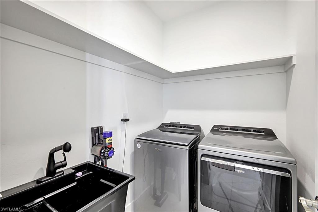 502 Southwest 25th Place Cape Coral, FL 33991 - Photo 20 of 34 a kitchen with a stove and a sink