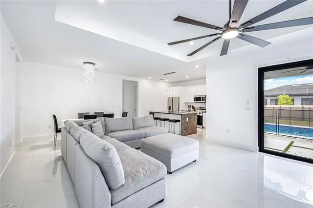 a living room with furniture kitchen and a chandelier