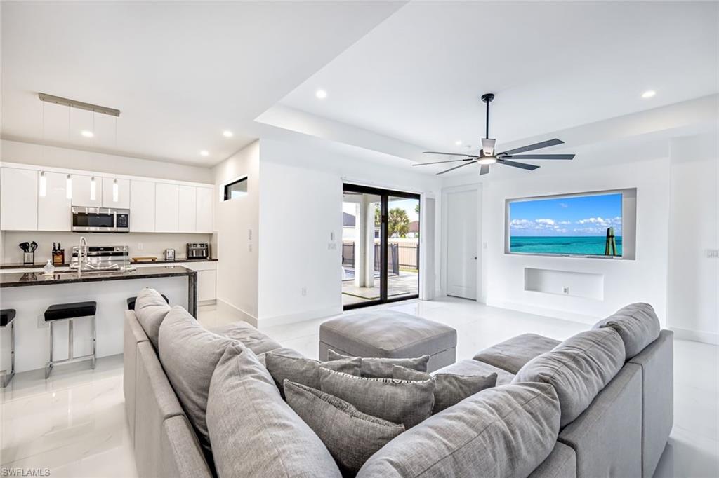 502 Southwest 25th Place Cape Coral, FL 33991 - Photo 23 of 34 a living room with furniture kitchen and a chandelier