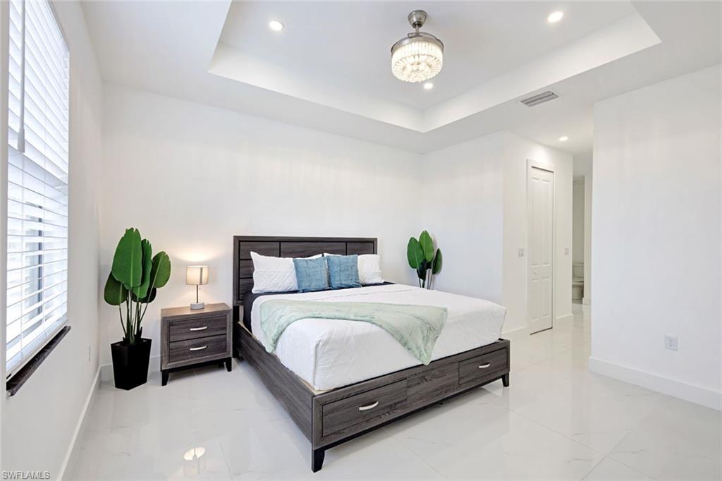 502 Southwest 25th Place Cape Coral, FL 33991 - Photo 29 of 34 a bedroom with a bed and a window