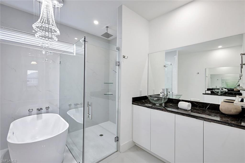 502 Southwest 25th Place Cape Coral, FL 33991 - Photo 32 of 34 a bathroom with a double vanity sink and a mirror