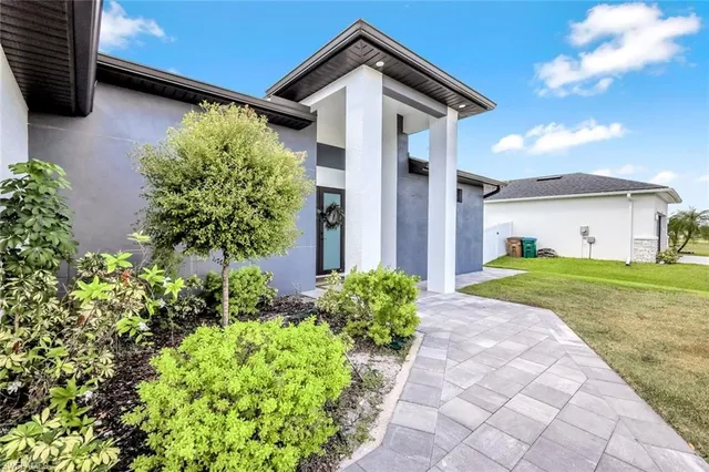 a front view of a house with garden
