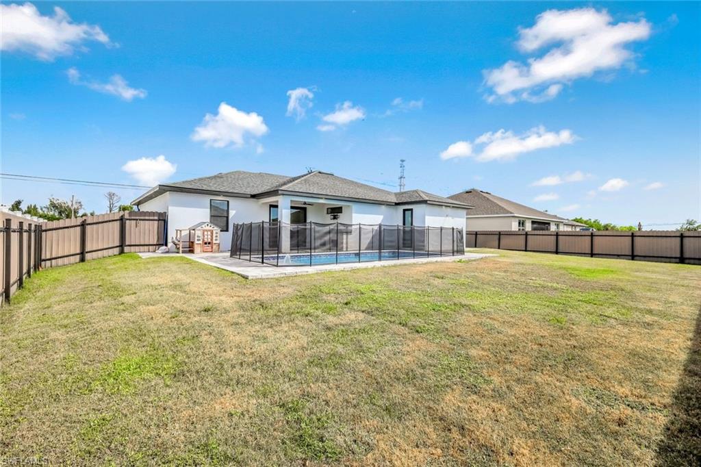 502 Southwest 25th Place Cape Coral, FL 33991 - Photo 5 of 34 a front view of a house with a yard