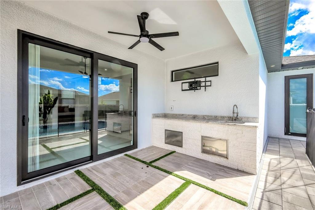 502 Southwest 25th Place Cape Coral, FL 33991 - Photo 7 of 34 a living room with a fireplace and a table