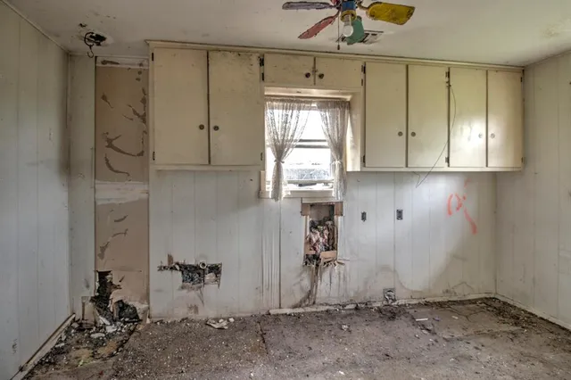 a bathroom with a granite countertop shower and a sink