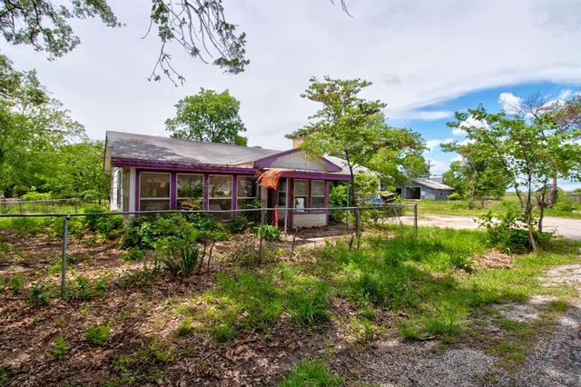 a view of a house with garden and porch