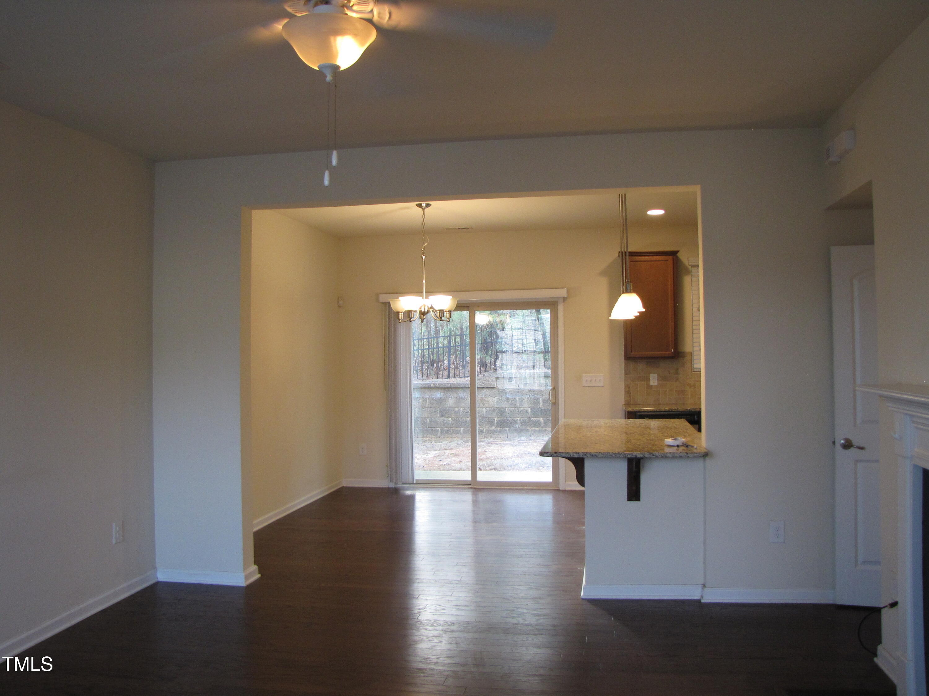 74 Pocono Drive Durham, NC 27705 - Photo 3 of 14 an empty room with wooden floor and windows
