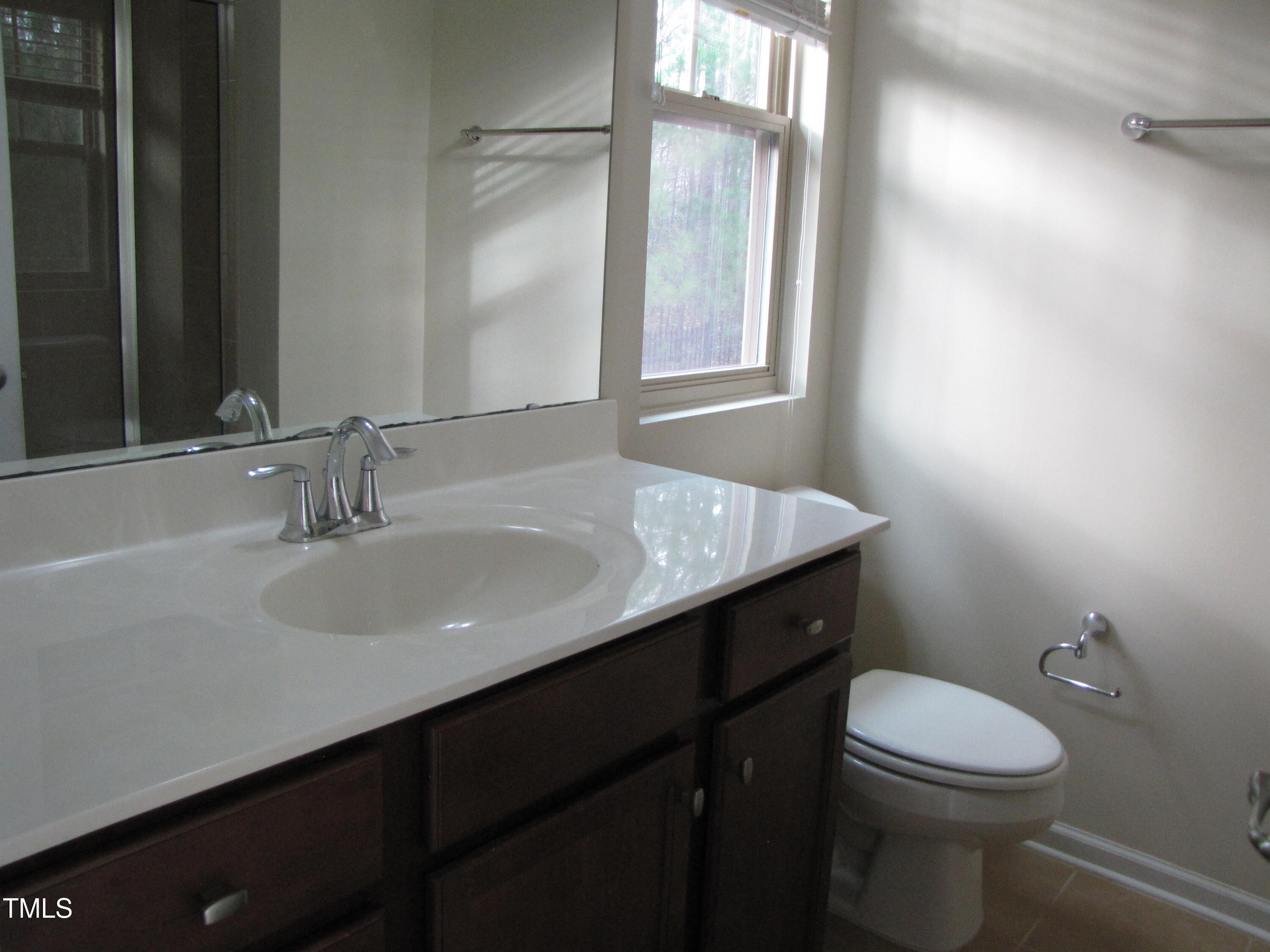 74 Pocono Drive Durham, NC 27705 - Photo 8 of 14 a bathroom with a sink a toilet and a mirror