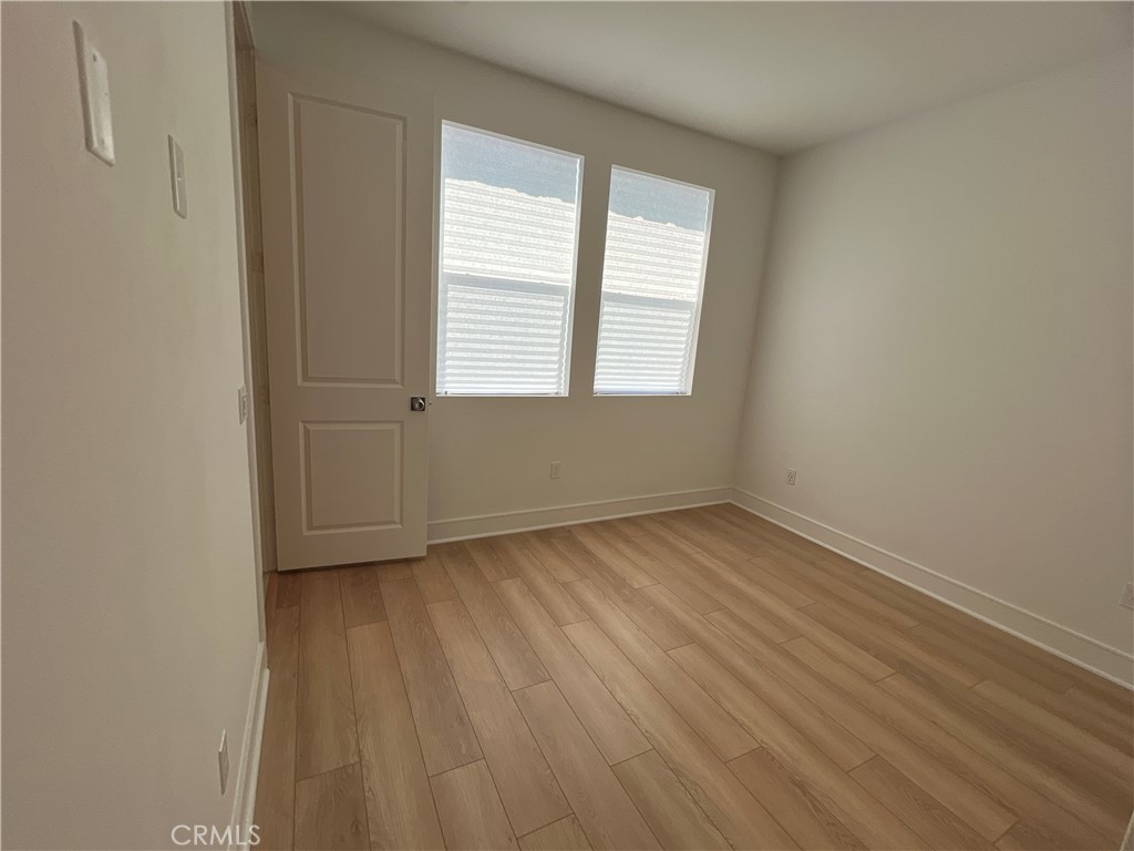 468 Palermo Lake Forest, CA 92630 - Photo 11 of 22 an empty room with wooden floor and windows