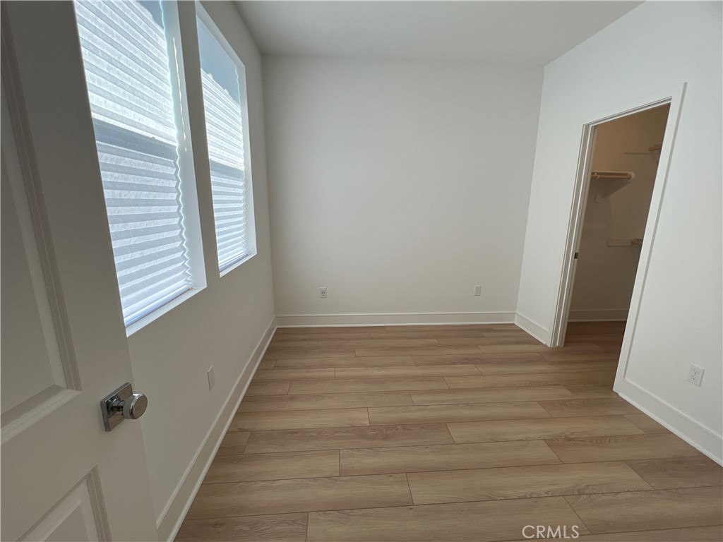 468 Palermo Lake Forest, CA 92630 - Photo 12 of 22 a view of an empty room with wooden floor and a window
