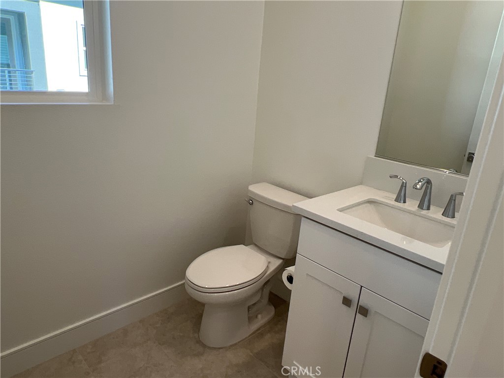 468 Palermo Lake Forest, CA 92630 - Photo 14 of 22 a white toilet sitting next to a bathroom sink