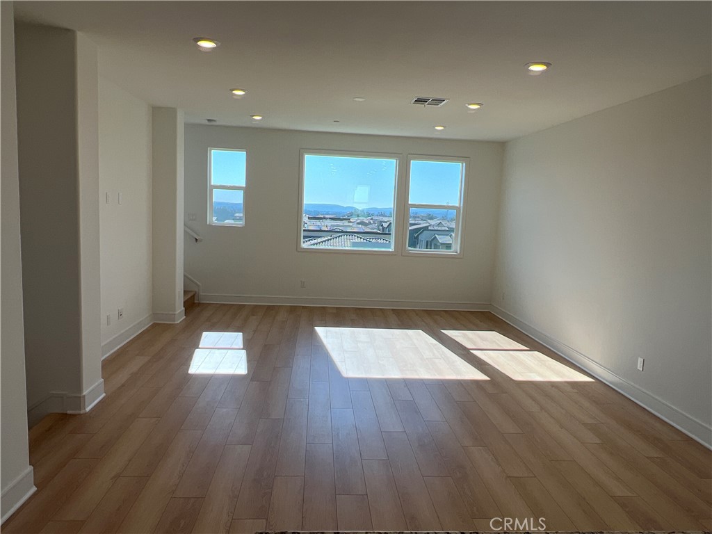 468 Palermo Lake Forest, CA 92630 - Photo 6 of 22 an empty room with wooden floor and windows