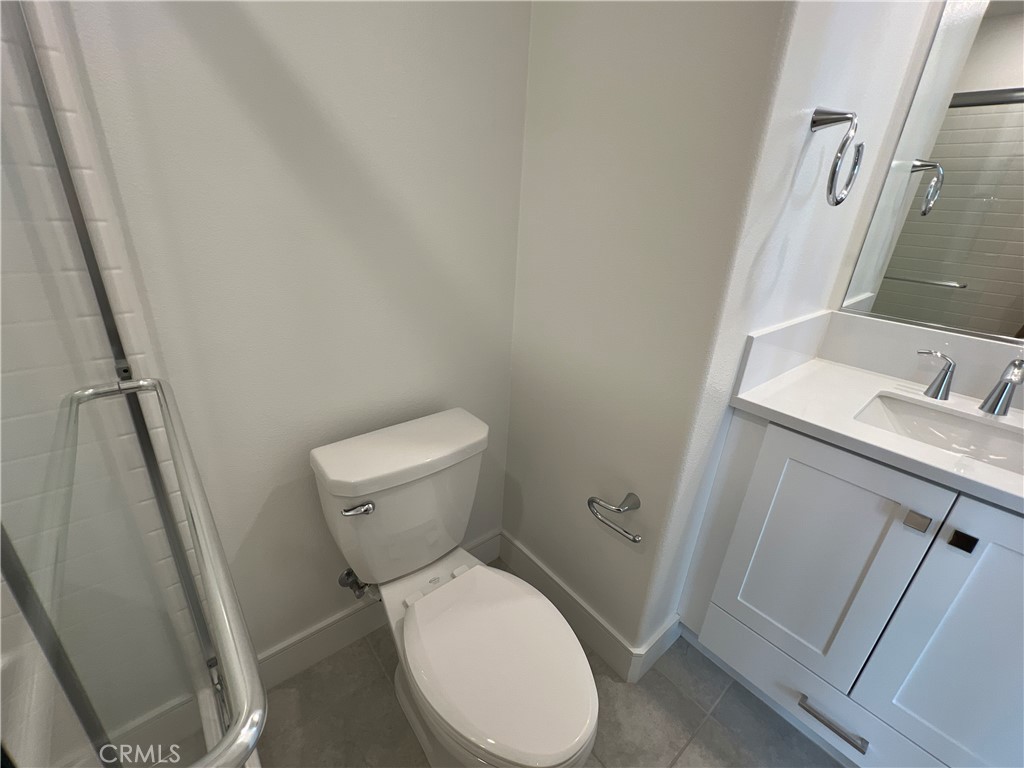 468 Palermo Lake Forest, CA 92630 - Photo 10 of 22 a white toilet sitting next to a sink and vanity