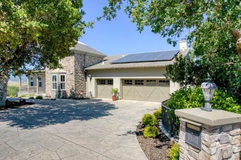 a front view of a house with a yard and outdoor seating