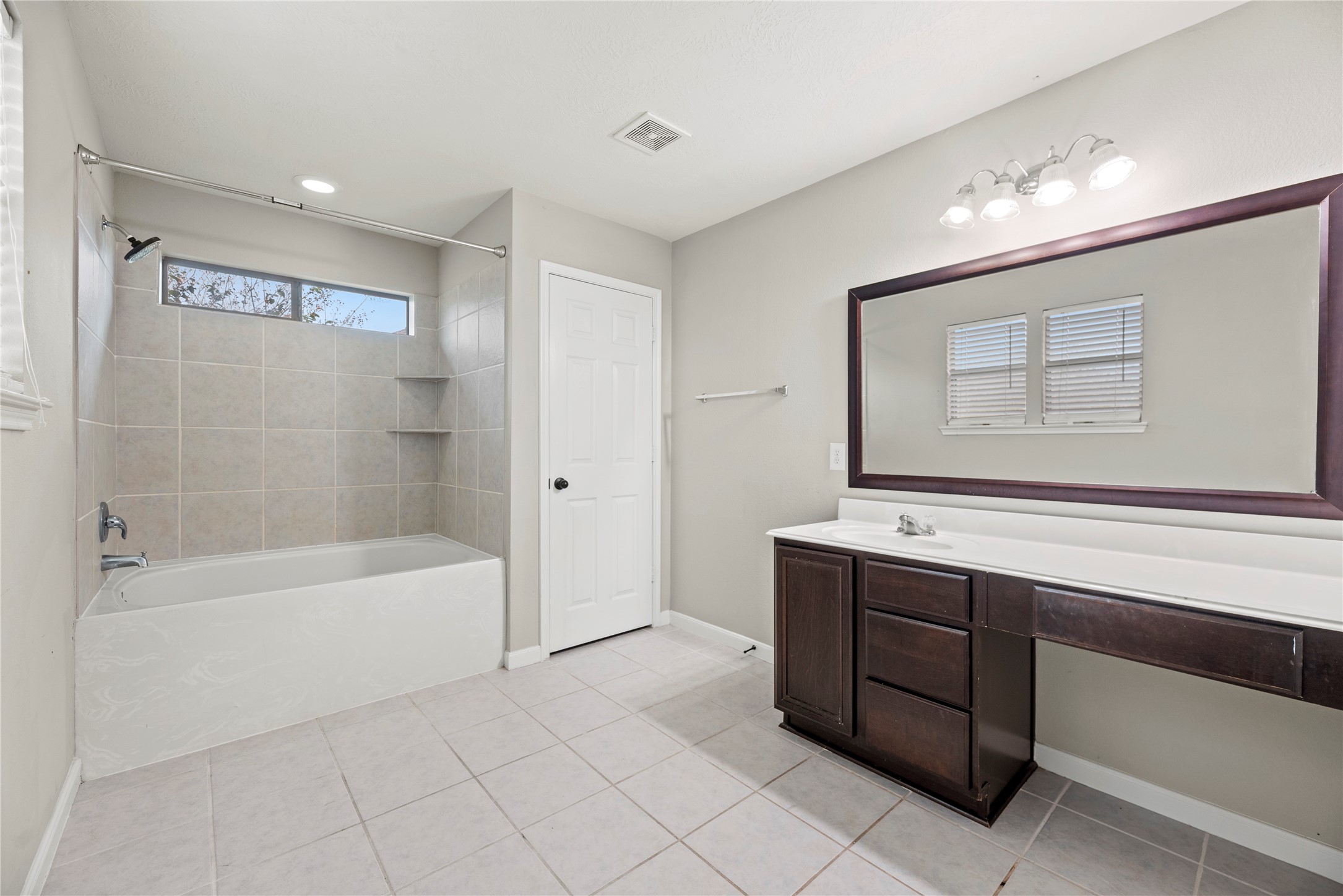 4103 Sherry Mist Lane Katy, TX 77449 - Photo 11 of 19 Step into your private bath, featuring a large vanity and a tub/shower combo that offer convenience and comfort for daily routines.