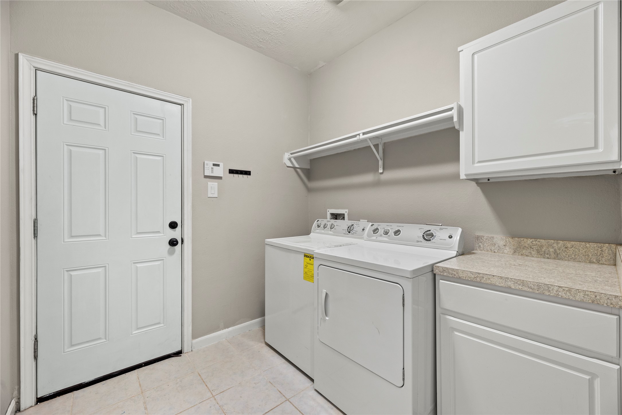 4103 Sherry Mist Lane Katy, TX 77449 - Photo 15 of 19 Experience convenience with the in-house utility room, thoughtfully designed with a dedicated laundry area.