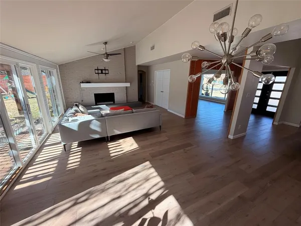 a living room with furniture and wooden floor
