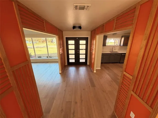 wooden floor in an empty room with a window